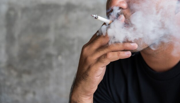 Close up asian man smoking cigarette. stop smoking concept