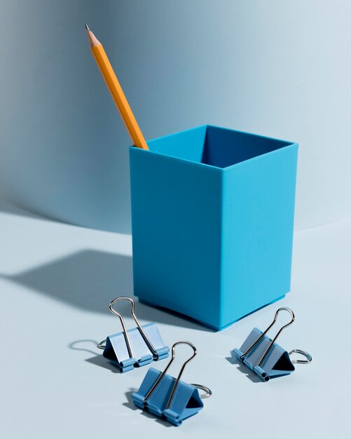 Close-up assortment of paper clips and pencil on desk