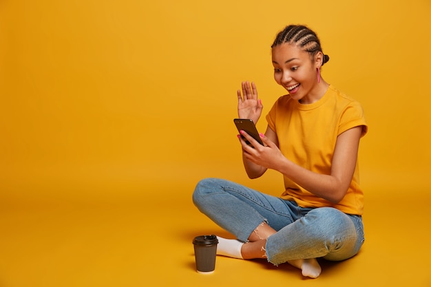 Close up on attractive carefree young woman sitting on the floor