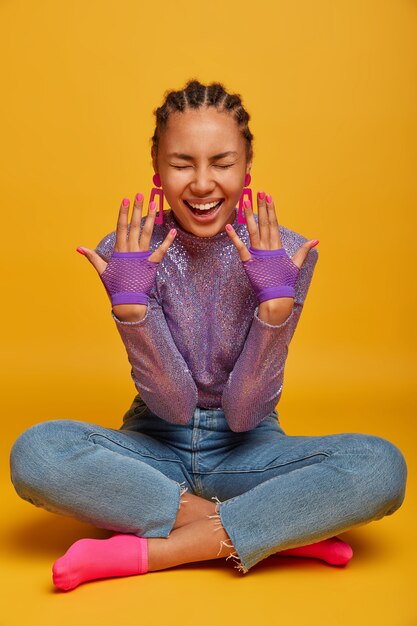 Close up on attractive carefree young woman sitting on the floor