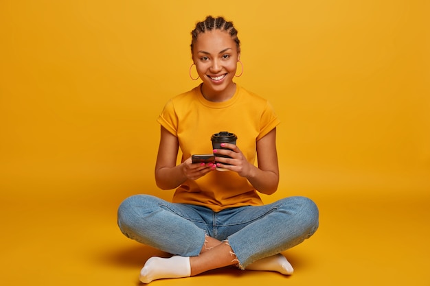 Close up on attractive carefree young woman sitting on the floor