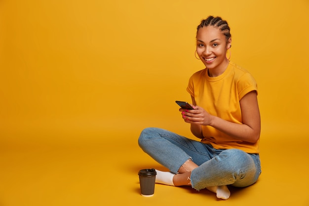 Close up on attractive carefree young woman sitting on the floor