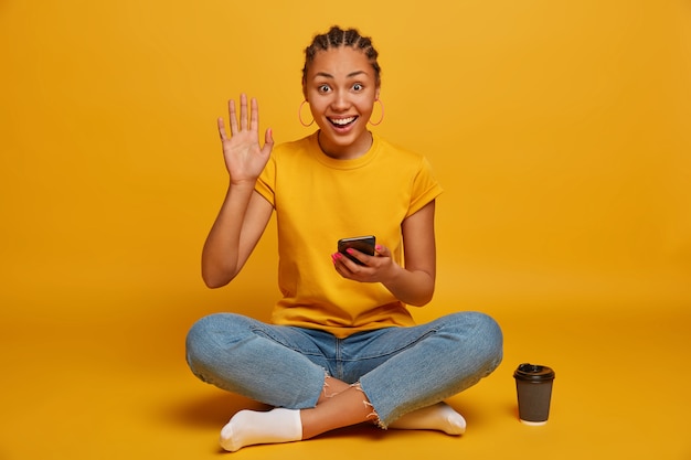 Close up on attractive carefree young woman sitting on the floor