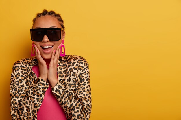 Close up on attractive carefree young woman wearing sunglasses