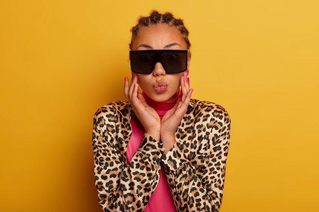 Close up on attractive carefree young woman wearing sunglasses