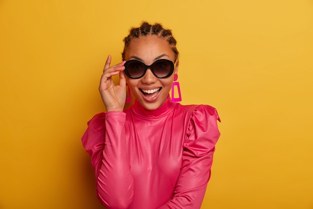 Close up on attractive carefree young woman wearing sunglasses