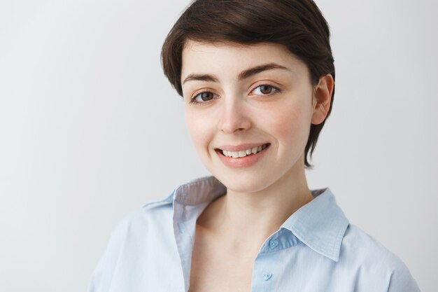 Close-up of attractive dreamy woman looking with hopeful smile