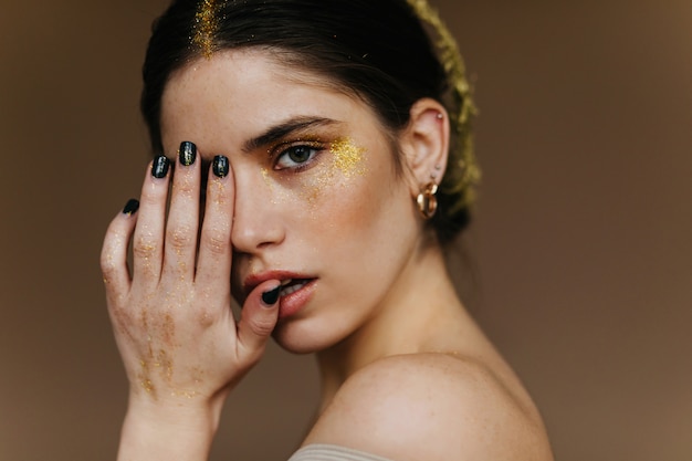 Close-up  attractive girl. White interested woman posing in golden