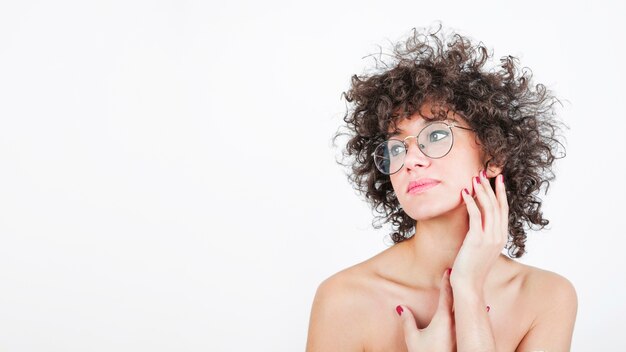 Close-up of an attractive woman touching her cheek gently