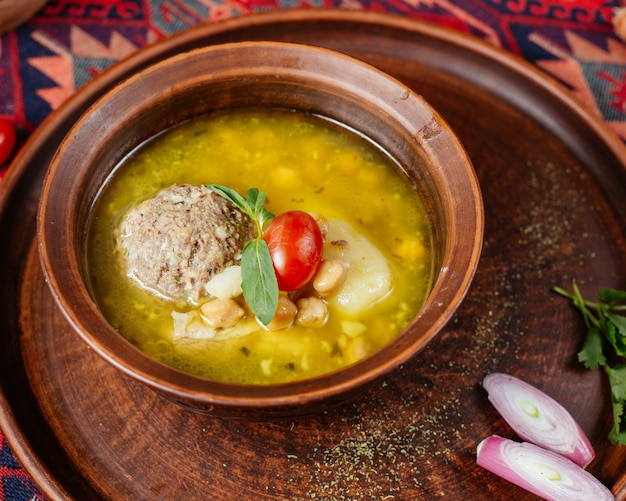 Close up of azerbaijani kufte-bozbash meatball soup with chickpeas and potato