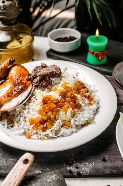 Close up of azerbaijani pilaf with roasted chicken lyavangi and roasted dried fruits