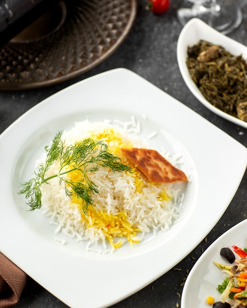 Close up of azerbaijani rice dish served with safran and crispy flatbread