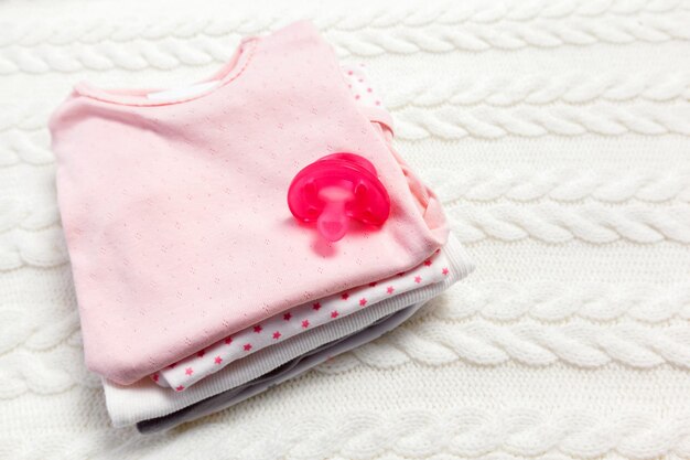 Close up of baby clothes for newborn on table