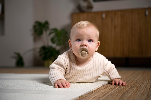 Close up on baby crawling and learning to walk