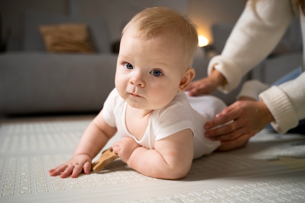 Close up on baby crawling and learning to walk