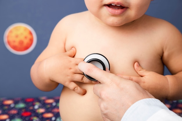 Close-up baby examination with stethoscope