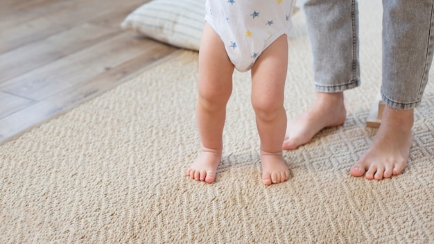 Close up baby walking with parent