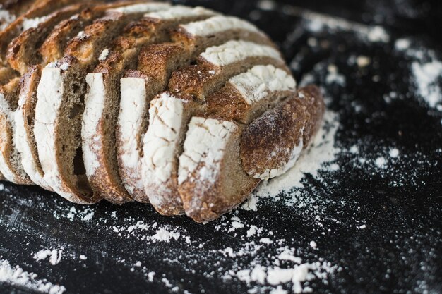 Close-up of baked bread slices on black backdrop