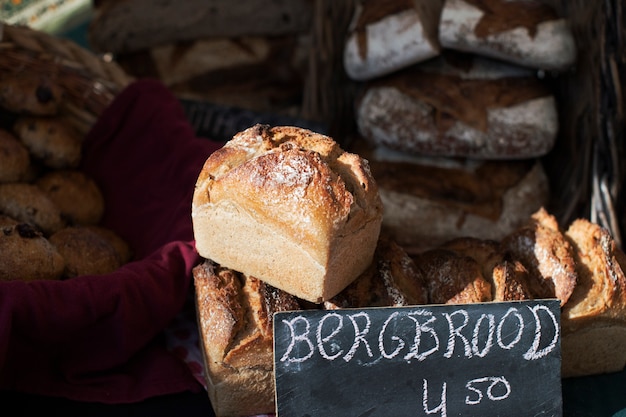 Close-up of baked bread with price tag on slate