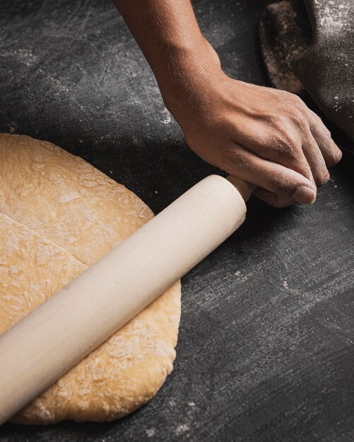 Close-up baker hand rolling composition 