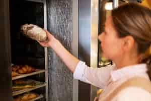 Free photo close up baker holding bread