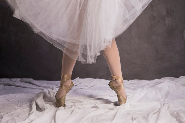 Close up ballerina in ballet shoes and skirt