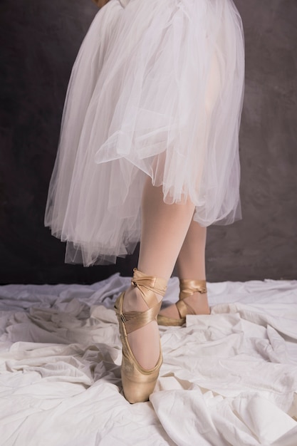Close up ballerina pointe shoes and skirt