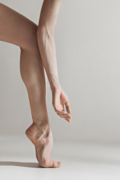 Close-up ballerina's legs on the white floor