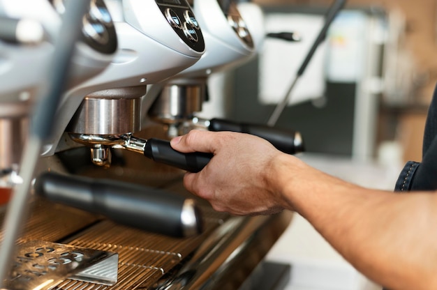 Close up barista using coffee machine