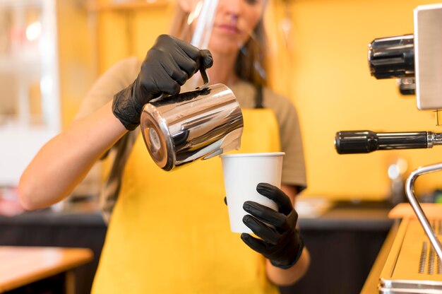 Close-up barista with face protection