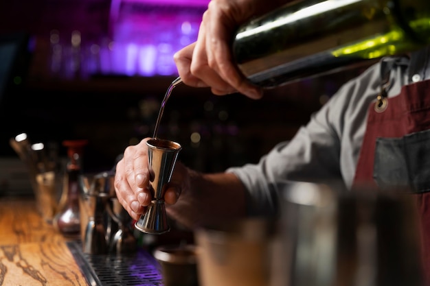 Close up on bartender and cocktail shaker