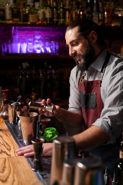 Close up on bartender and cocktail shaker