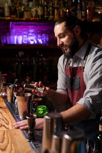 Close up on bartender and cocktail shaker