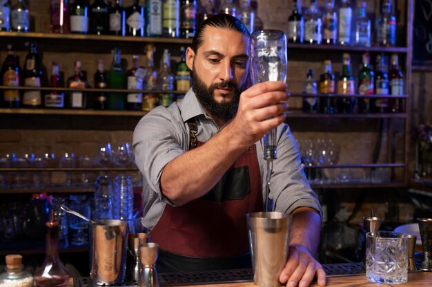 Close up on bartender and cocktail shaker