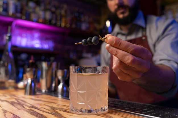 Free photo close up on bartender and cocktail shaker