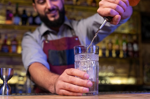 Close up on bartender and cocktail shaker