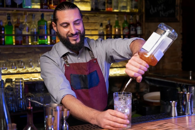 Close up on bartender and cocktail shaker