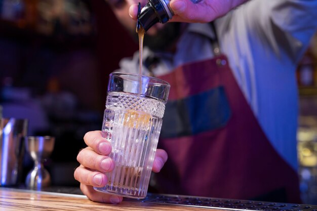 Close up on bartender and cocktail shaker