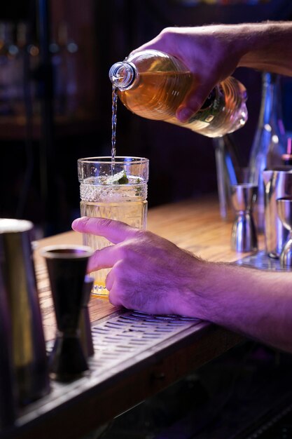 Close up on bartender and cocktail shaker