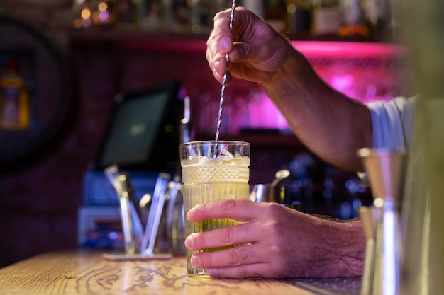 Close up on bartender and cocktail shaker