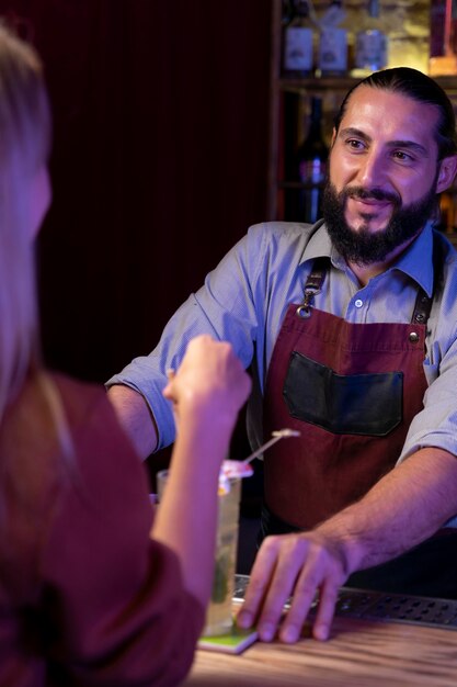 Close up on bartender and cocktail shaker