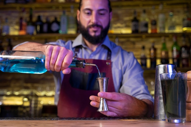 Close up on bartender and cocktail shaker