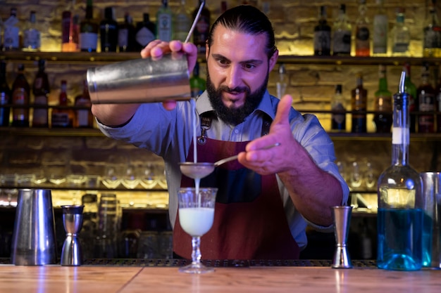 Close up on bartender and cocktail shaker