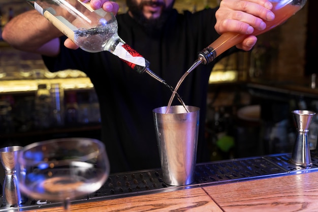 Close up on bartender and cocktail shaker