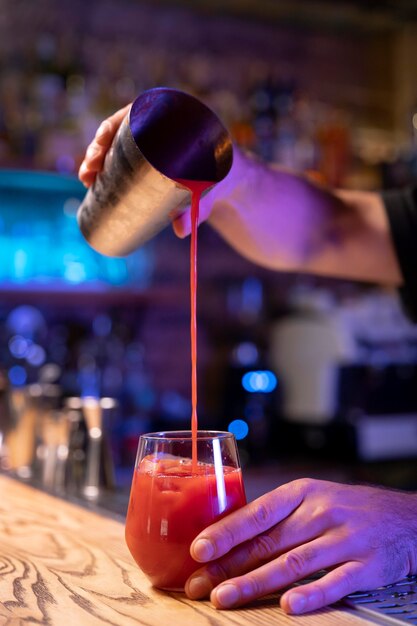 Close up on bartender and cocktail shaker