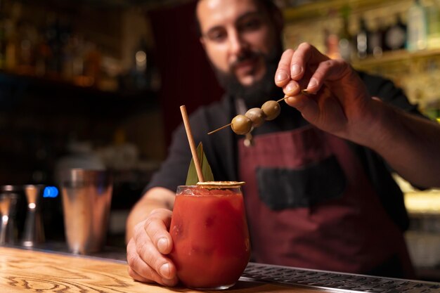 Close up on bartender and cocktail shaker