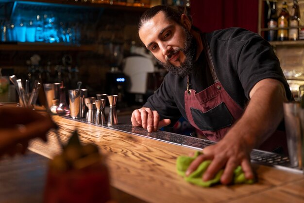 Close up on bartender and cocktail shaker