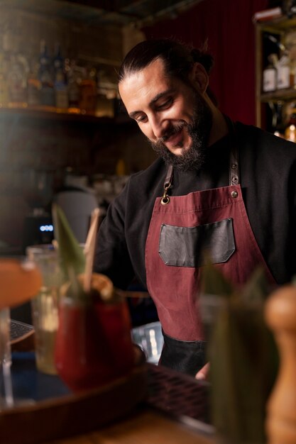 Close up on bartender and cocktail shaker