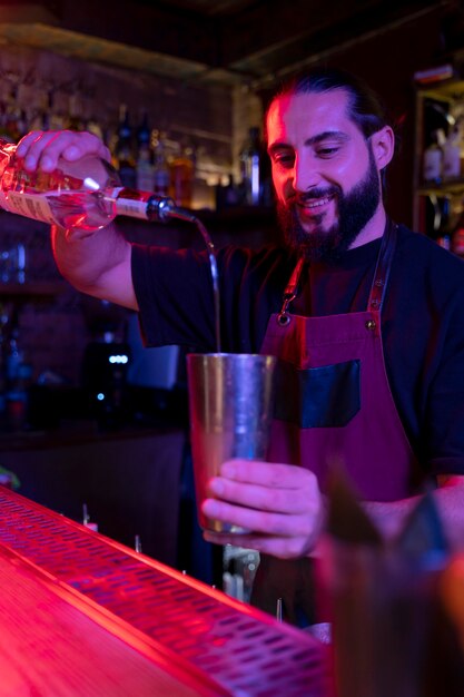 Close up on bartender and cocktail shaker