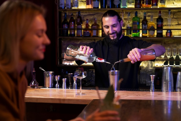 Close up on bartender and cocktail shaker